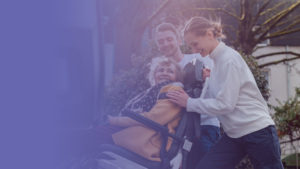 Elderly woman in wheelchair being helped into her wheelchair van