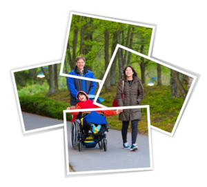 Happy child in wheelchair enjoying the outdoors with his family