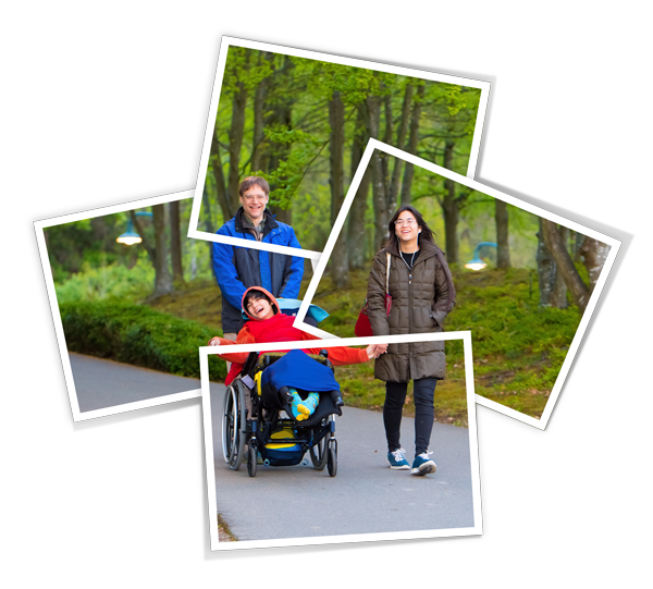 Happy child in wheelchair enjoying the outdoors with his family