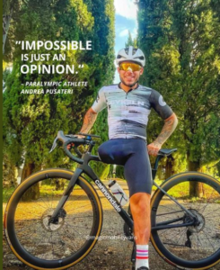 Picture of Andrea Pusateri, Paralympic athlete, standing in front of his bike.