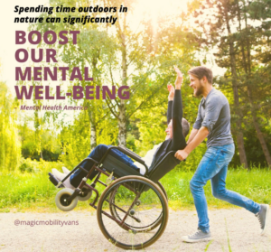 elderly man in wheelchair being pushed outside in nature by son.